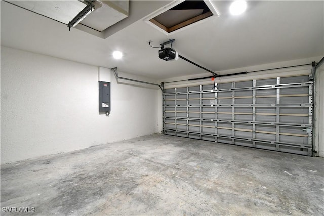 garage with a garage door opener and electric panel