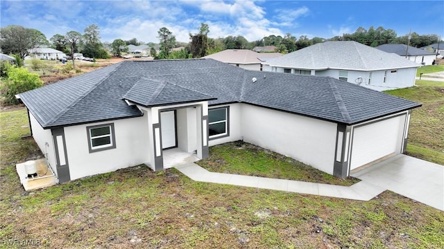 ranch-style house with a garage and a front lawn