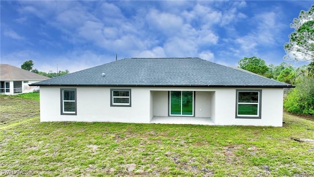 back of house with a patio and a yard