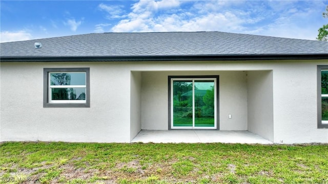 rear view of house featuring a yard and a patio area