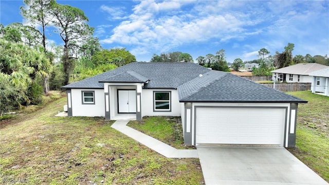 view of front of home featuring a garage and a front yard