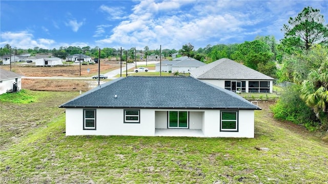 back of house featuring a yard