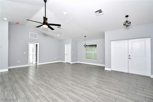 unfurnished living room featuring lofted ceiling and ceiling fan