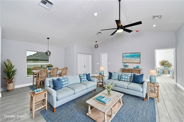 living room with ceiling fan and lofted ceiling