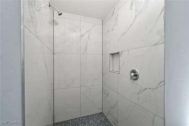 bathroom featuring a tile shower