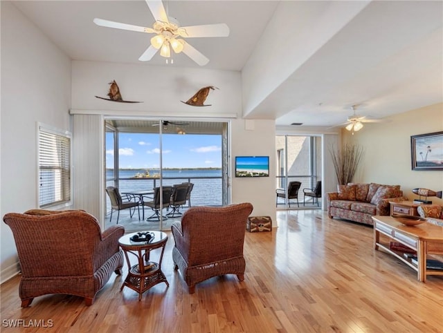 living room with ceiling fan and light wood-type flooring