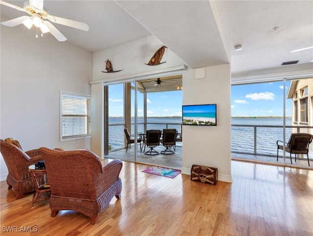 living room with ceiling fan and light wood-type flooring