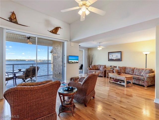 living room featuring ceiling fan and light hardwood / wood-style flooring