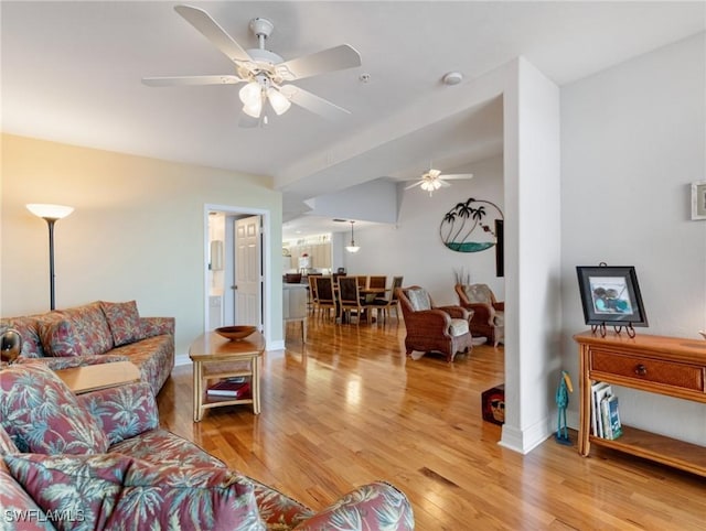 living room with wood-type flooring and ceiling fan