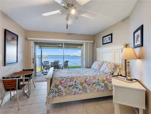 tiled bedroom with a water view, access to exterior, and ceiling fan