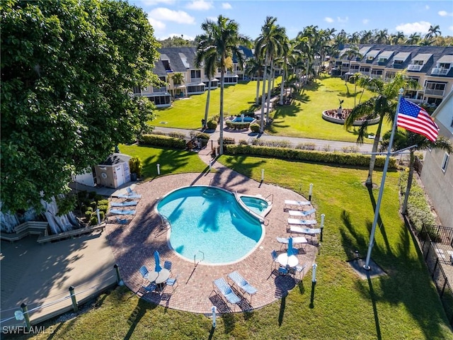 view of swimming pool featuring a lawn and a patio area