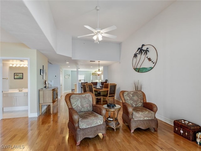 sitting room featuring lofted ceiling, ceiling fan, and light wood-type flooring