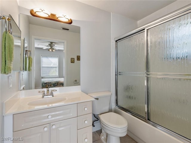 full bathroom with vanity, ceiling fan, toilet, and combined bath / shower with glass door