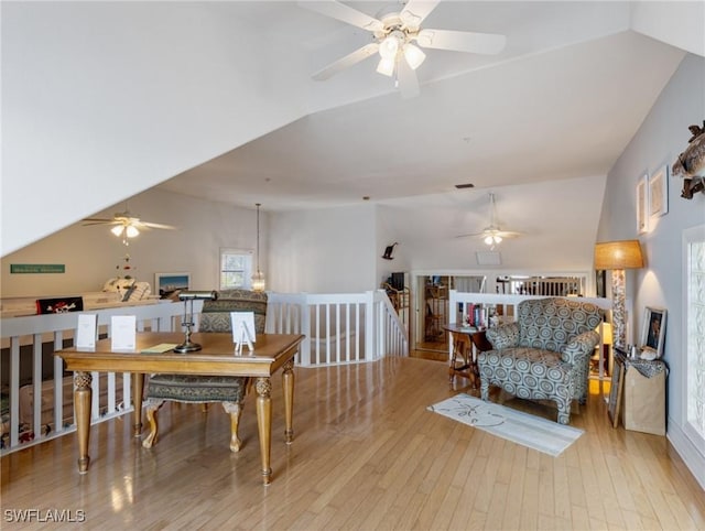 interior space with ceiling fan, lofted ceiling, and light hardwood / wood-style floors