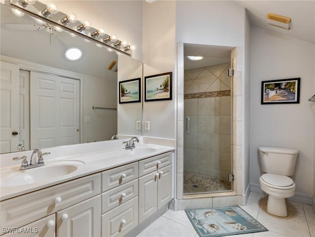 bathroom featuring vanity, a shower with door, vaulted ceiling, and tile patterned floors