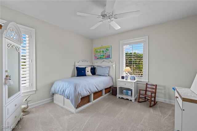 bedroom with ceiling fan and light carpet