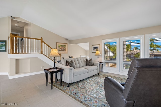 living room with light tile patterned floors and vaulted ceiling