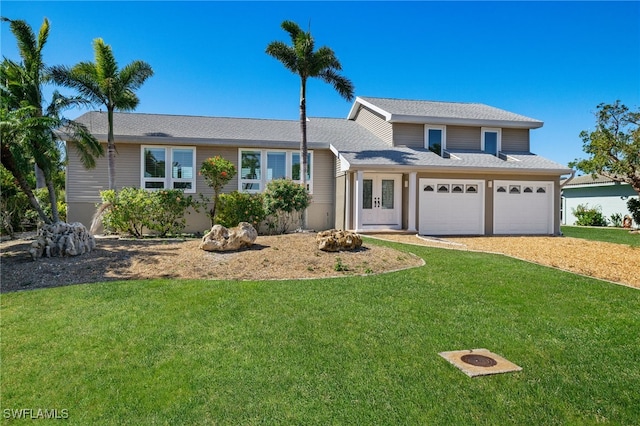 view of front of property featuring a garage and a front yard