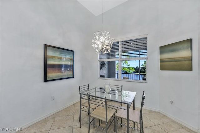 dining area featuring light tile patterned flooring and a chandelier