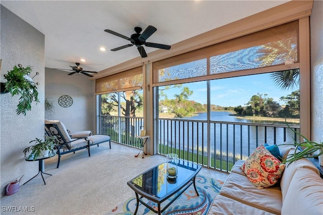 sunroom / solarium featuring a water view