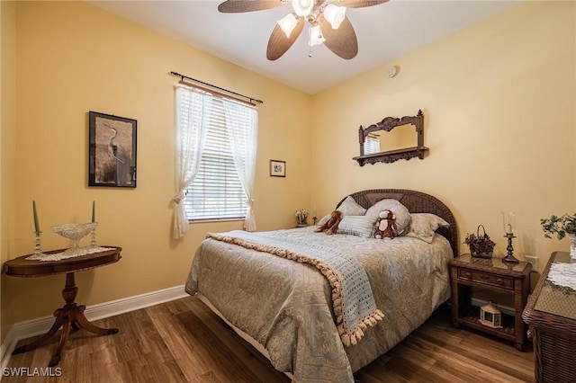 bedroom featuring ceiling fan, baseboards, and wood finished floors