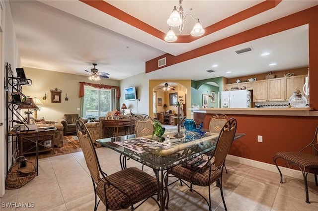 dining area featuring arched walkways, visible vents, baseboards, and light tile patterned floors