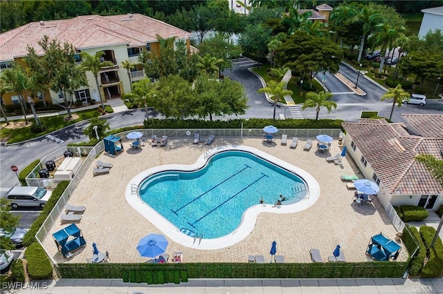 pool with fence and a patio