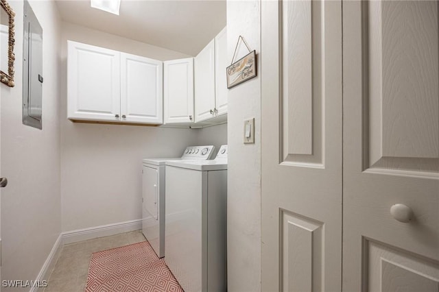 laundry room featuring light tile patterned floors, cabinet space, separate washer and dryer, electric panel, and baseboards