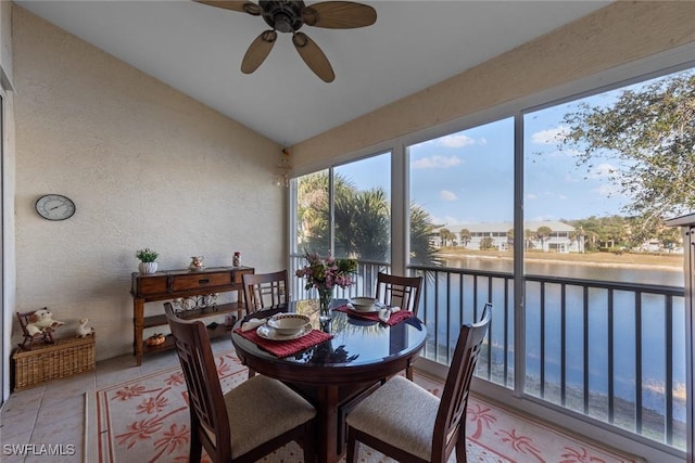 sunroom featuring vaulted ceiling, a water view, and ceiling fan