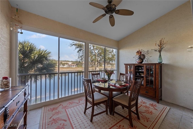 sunroom / solarium with vaulted ceiling, a water view, and ceiling fan