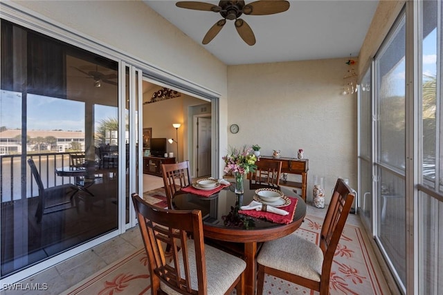 sunroom featuring ceiling fan