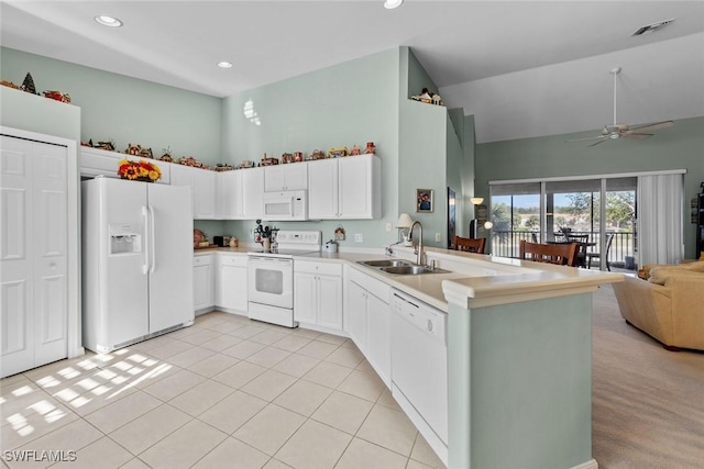 kitchen with sink, white appliances, high vaulted ceiling, white cabinets, and kitchen peninsula