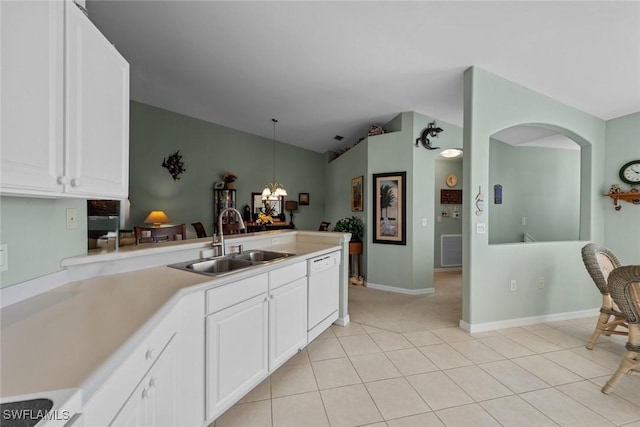 kitchen with vaulted ceiling, pendant lighting, white cabinetry, sink, and white dishwasher