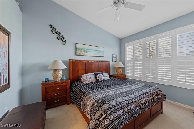 bedroom featuring ceiling fan, light colored carpet, and vaulted ceiling