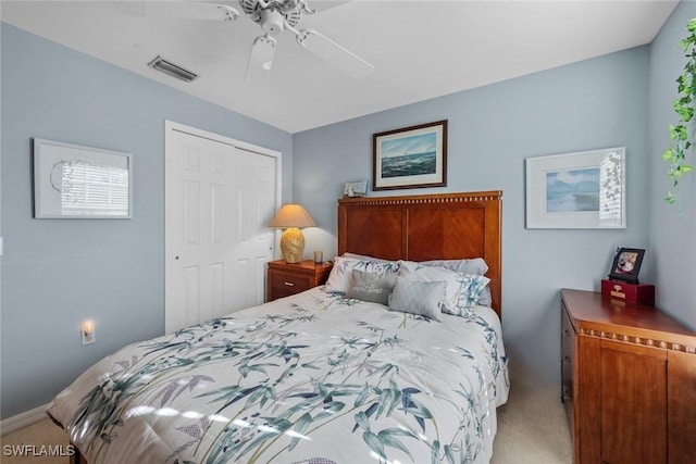 carpeted bedroom with ceiling fan and a closet