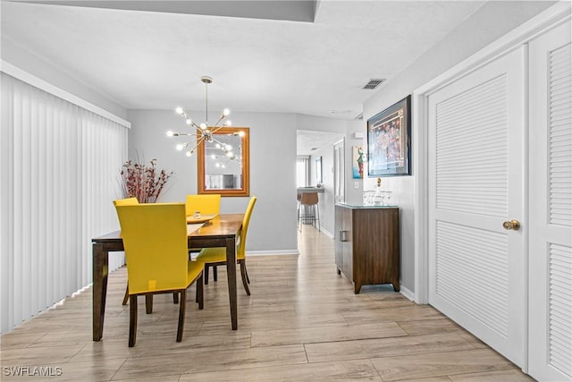 dining space featuring a chandelier and light hardwood / wood-style floors