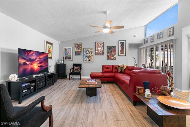 living room with lofted ceiling, hardwood / wood-style floors, a textured ceiling, and ceiling fan