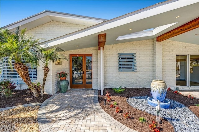 view of exterior entry featuring french doors