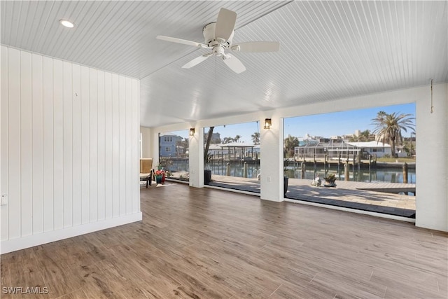 interior space featuring a water view, ceiling fan, and hardwood / wood-style floors