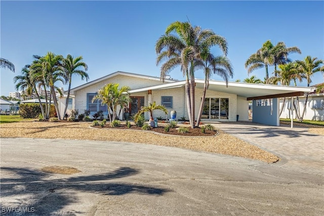 ranch-style home featuring a carport