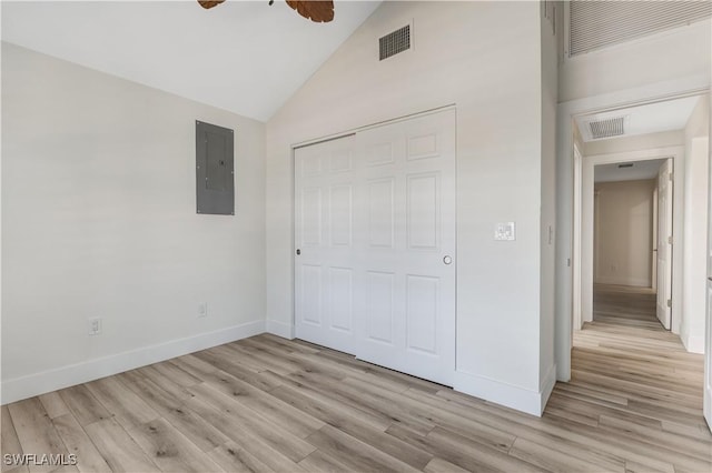 unfurnished bedroom featuring electric panel, a closet, and light wood-type flooring