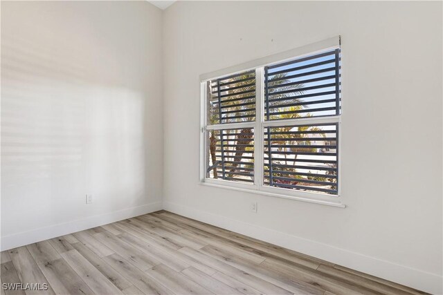 empty room with light hardwood / wood-style flooring