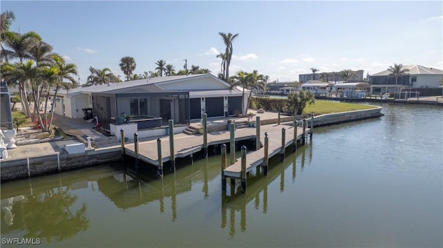 view of dock featuring glass enclosure and a water view