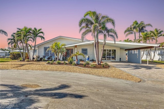 ranch-style house featuring a carport