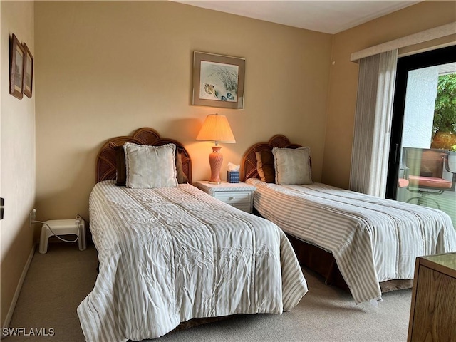 bedroom featuring baseboards, carpet flooring, and access to exterior