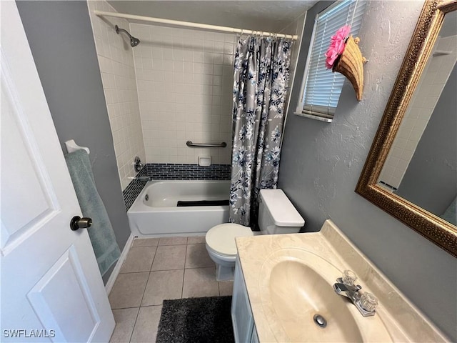 full bathroom featuring a textured wall, tile patterned flooring, toilet, shower / tub combo, and vanity