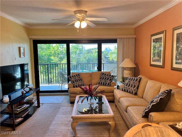 living area featuring a ceiling fan, carpet flooring, and crown molding