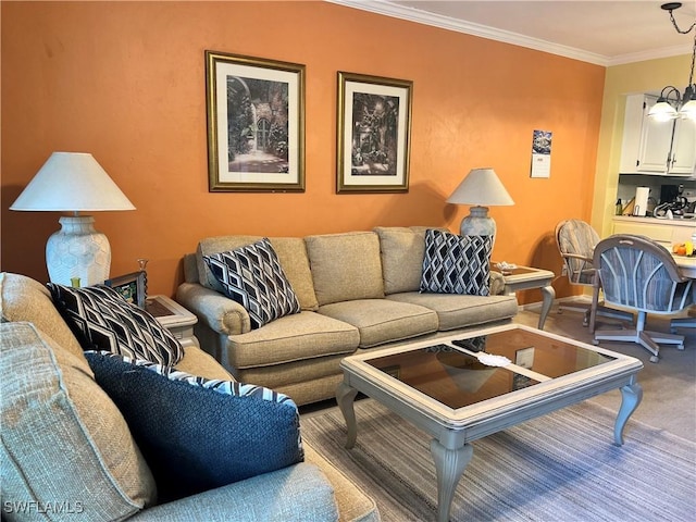 carpeted living area with baseboards, a chandelier, and crown molding