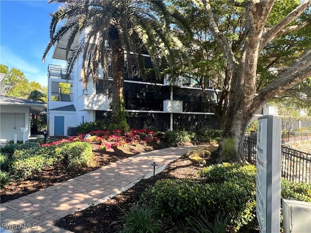 view of home's community featuring fence