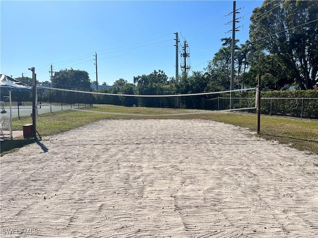 view of property's community with volleyball court and fence